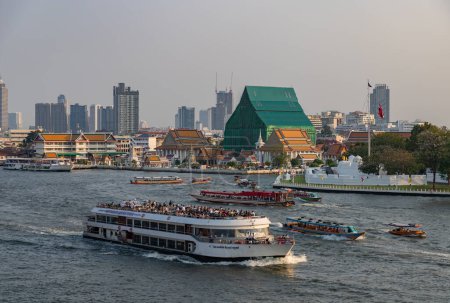 A picture of multiple boats cruising the Chao Phraya River in Bangkok.