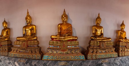 A picture of golden Buddha statues at the Wat Pho Temple.