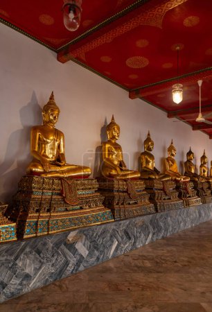 A picture of golden Buddha statues at the Wat Pho Temple.