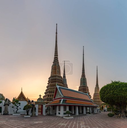 A picture of the spires at the Wat Pho Temple at sunset.