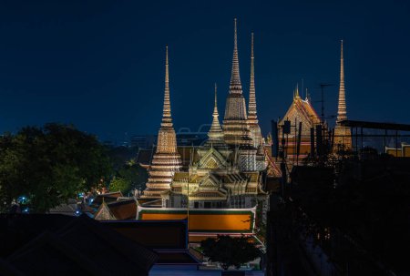 A picture of the spires of the Wat Pho Temple at night.
