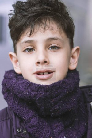 Photo for Portrait of a handsome boy with green eyes in a winter scarf - Royalty Free Image