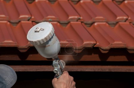 Photo for Closeup of roof painting .person painting roof - Royalty Free Image