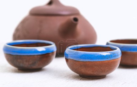 Foto de Tetera oriental tradicional y tazas de té en escritorio de madera blanca - Imagen libre de derechos