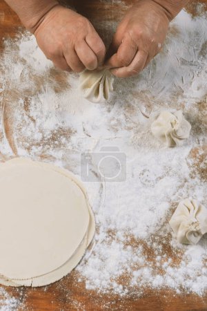 Photo for Chef cook making khinkali  on wooden table. Process preparation georgian meal. food concept. - Royalty Free Image