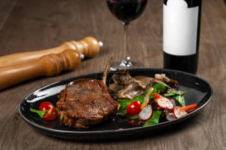Photo for Pork steak with sauce and salad on wooden table, closeup - Royalty Free Image
