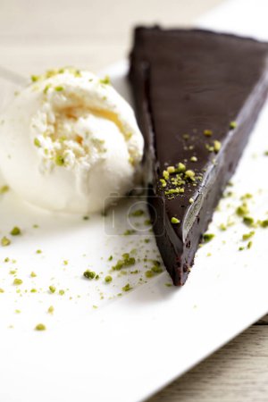 Foto de Pastel de chocolate brownie con helado y pistacho sobre fondo blanco - Imagen libre de derechos