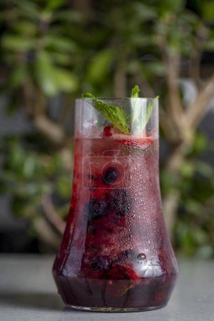Foto de Refreshing summer drink with berries and mint in a glass. lemonade - Imagen libre de derechos
