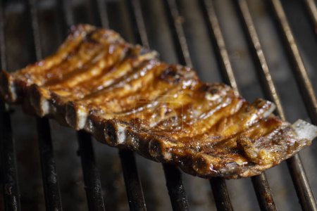 Photo for Grilling ribs on a barbecue grill. Close-up. - Royalty Free Image