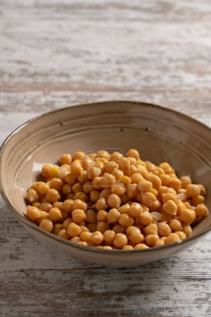 Photo for Chickpeas in a  bowl on a wooden background. - Royalty Free Image