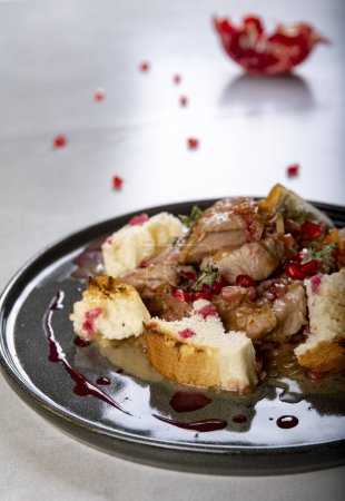 Photo for Braised turkey with pomegranate seeds and toasted baguette - Royalty Free Image