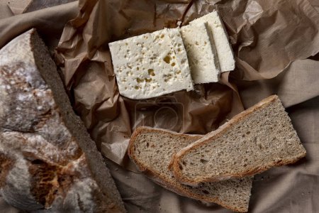 Photo for Goat or sheep cheese and bread on the table - Royalty Free Image