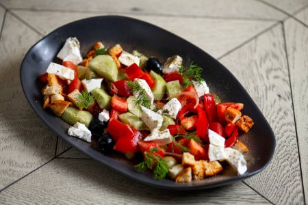 Photo for Greek salad with feta cheese, tomatoes, cucumbers, onions and croutons - Royalty Free Image