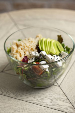Photo for Salad with quinoa, avocado and feta cheese in a glass bowl - Royalty Free Image