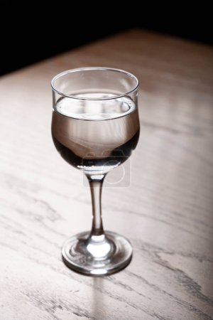 Photo for Glass of water on a wooden table. Selective focus. Toned. - Royalty Free Image