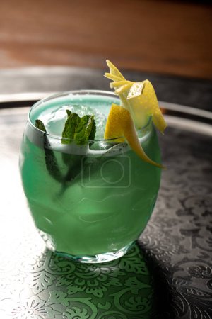 Photo for Cocktail with mint and lemon on a table in a restaurant - Royalty Free Image