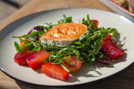 Photo for Fried goat cheese , cherry tomatoes and arugula . - Royalty Free Image