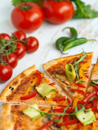 Photo for Vegetarian pizza with cheese, tomato, pepper and avocado in white wooden desk.Top view - Royalty Free Image
