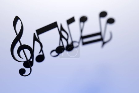 Foto de Musical notes and symbols with curves and swirls on a white  background. 3D illustration - Imagen libre de derechos