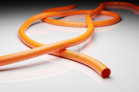 Foto de 3d illustration orange hollow plastic hose isolated on white background - Imagen libre de derechos