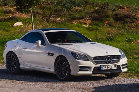 Photo for Side, Turkey -January 21, 2023:  white Mercedes SLK55 AMG   is parked  on the street on a warm summer day - Royalty Free Image
