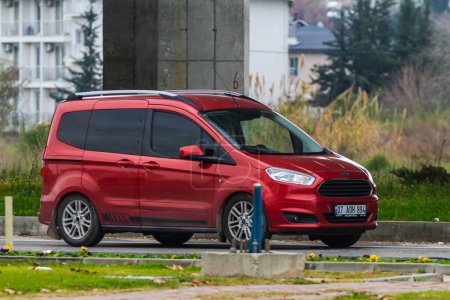 Foto de Side, Turkey -January 21, 2023:    red Ford Tourneo Courier   driving on the street on a warm summer day - Imagen libre de derechos