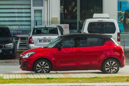 Photo for Side, Turkey -January 21, 2023:   red Suzuki Swift  is parked  on the street on a warm   day - Royalty Free Image