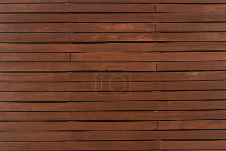 Photo for Close-up of a   brown wooden  wall  painted a very long time and the paint peeled off.  Brown texture background - Royalty Free Image