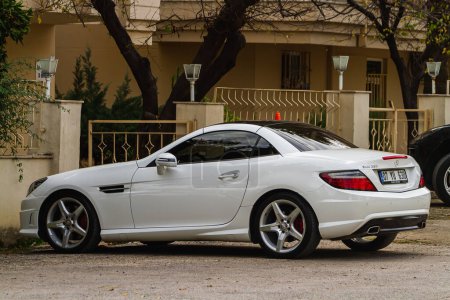 Photo for Side, Turkey -January 22, 2023:   white Mercedes-Benz SLK-class  250  is parked  on the street on a warm day against the backdrop of a fence - Royalty Free Image
