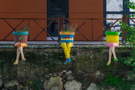 Téléchargez les photos : Gros plan de pots multicolores en forme de personnes avec des jambes - en image libre de droit