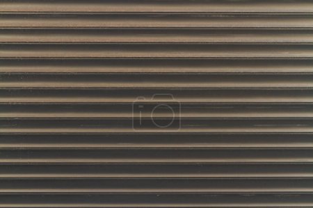 Photo for Close-up of melantic gray roller shutters covering a shop window - Royalty Free Image