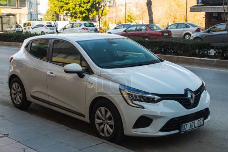 Photo for Side, Turkey -January 23, 2023:    white Renault Clio  is parked on a warm summer day against the backdrop of a  street - Royalty Free Image