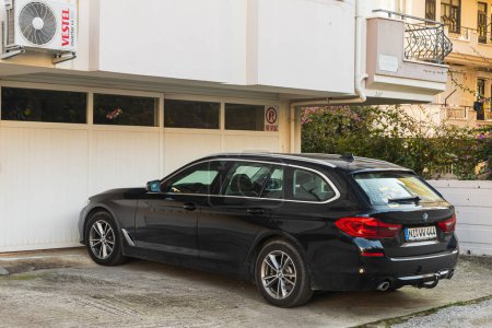 Photo for Side, Turkey -January 21, 2023:    black   BMW 3-series  is parked  on the street in city against the backdrop of a buildung,  house - Royalty Free Image