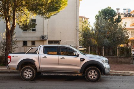 Photo for Side, Turkey -January 22, 2022:    silver  pickup Ford Ranger is parked  on the street on a warm day against the backdrop of a fence, garden - Royalty Free Image