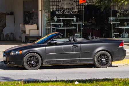 Photo for Side, Turkey -January 24, 2023: black Volvo c70, side  view,   is  parking  on the street on a warm day against the backdrop of a building - Royalty Free Image