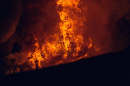 Photo for House on fire at night. Topics of arson and fires, disasters and extreme events. - Royalty Free Image