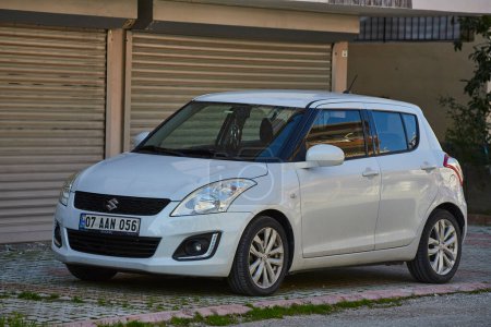 Photo for Side, Turkey - February 11, 2023:  white  Suzuki Swift  is parked  on the street on a warm   day - Royalty Free Image