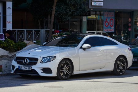 Photo for Side, Turkey -February  11 2023: white  Mercedes-Benz E-class is parked  on the street on a warm  day - Royalty Free Image
