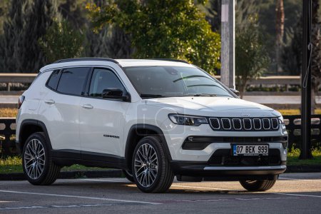Photo for Side, Turkey -February 18, 2023:    white Jeep Compass   is parked  on the street on a warm day against the backdrop of a  street - Royalty Free Image