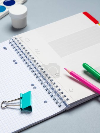 Photo for Top view of a flat work desk lies a notebook with blank sheets and stationery. Template for women's blogs in social networks - Royalty Free Image