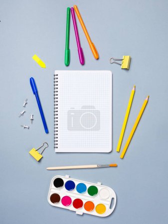 Photo for Creative flat design desktop mockup with empty notebook, stationery on blue background - Royalty Free Image
