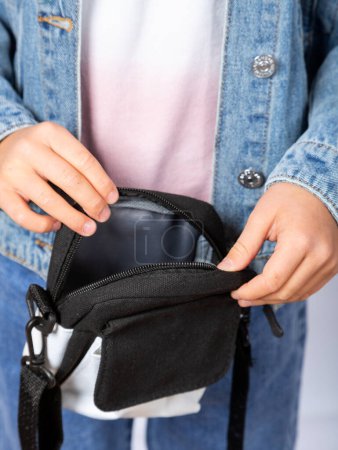 Photo for Close-up of a girl showing a small cute bag inside - Royalty Free Image