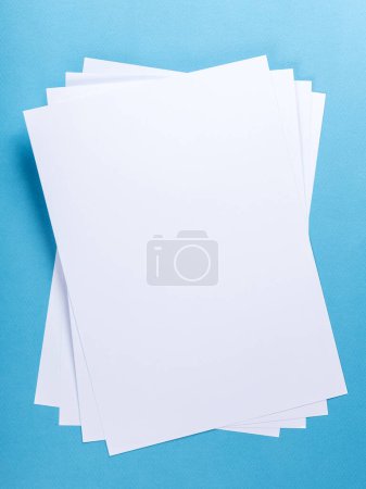 Photo for White Paper sheet background  isolated on blue, close up - Royalty Free Image