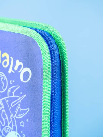 Photo for Close-up of a zipper on a blue school pencil case on a blue background. Back to school. copy space - Royalty Free Image
