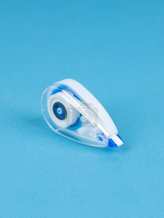 Photo for Close up of the correction tape isolated on blue background.  Image of a correction tape - Royalty Free Image