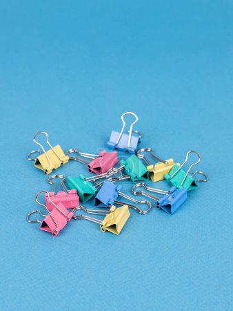 Photo for Colorful   paperclips isolated on blue background, close up - Royalty Free Image