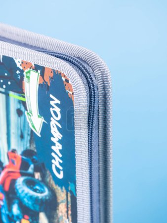 Photo for Close-up gray  zipper on a school pencil case on a blue background - Royalty Free Image