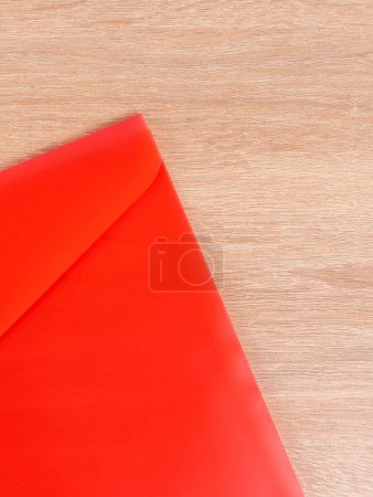 Photo for Close-up view of red plastic document folder on office table - Royalty Free Image