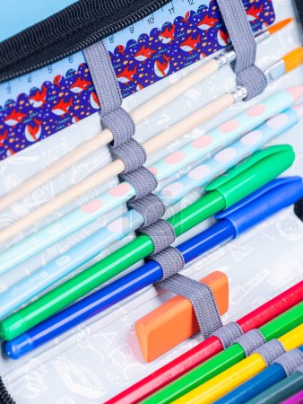 Photo for Close up of school supplies in pencil case on blue background with clipping path - Royalty Free Image