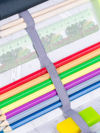 Téléchargez les photos : Gros plan des fournitures scolaires dans un étui à crayons sur fond bleu avec chemin de coupe - en image libre de droit